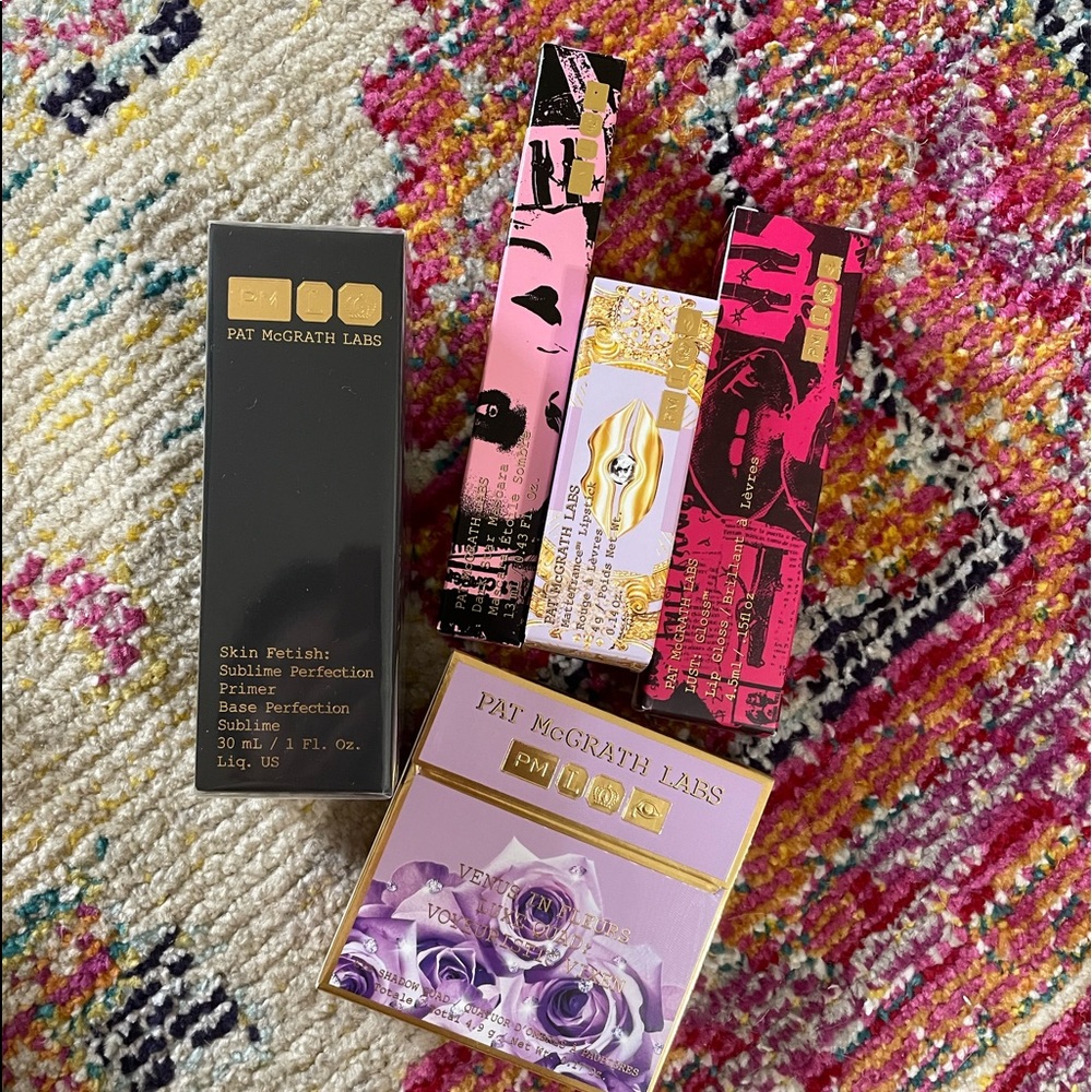 collection of Pat McGrath Labs makeup - eyeshadow palette, primer, lipstick